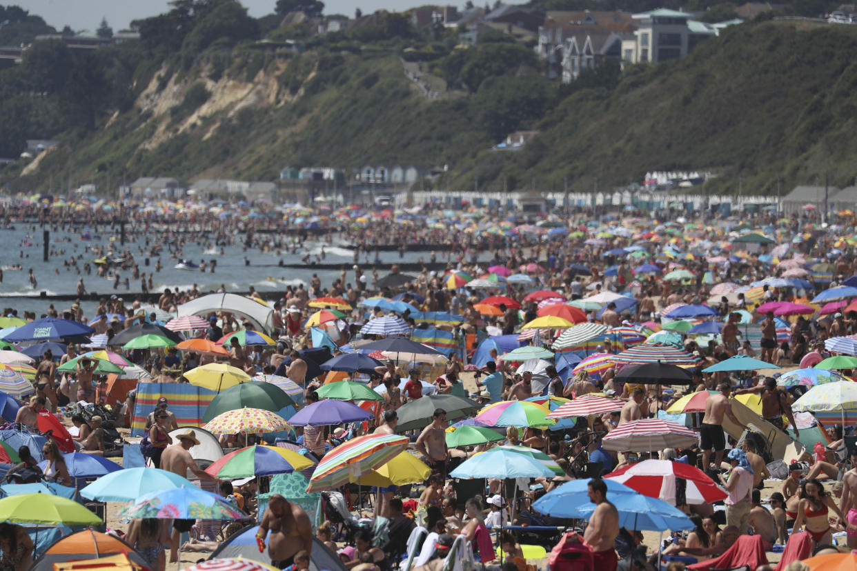 Crowds gather on the beach in Bournemouth as the UK experience a heat wave, in Bournemouth, England, Thursday, June 25, 2020. (Andrew Matthews/PA via AP)