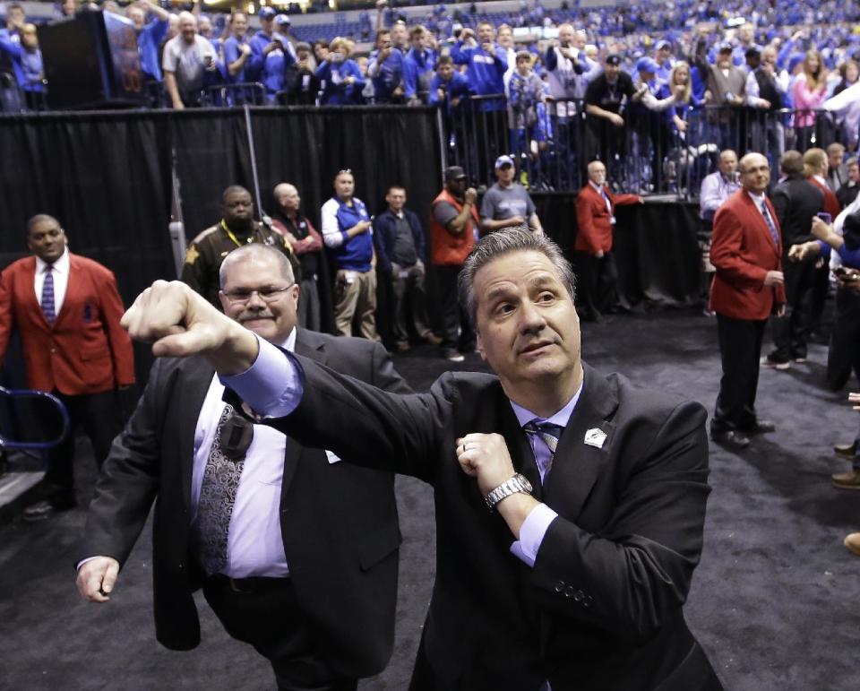 Kentucky head coach John Calipari celebrates after an NCAA Midwest Regional final college basketball tournament game against Michigan Sunday, March 30, 2014, in Indianapolis. Kentucky won 75-72 to advance to the Final Four. (AP Photo/David J. Phillip)