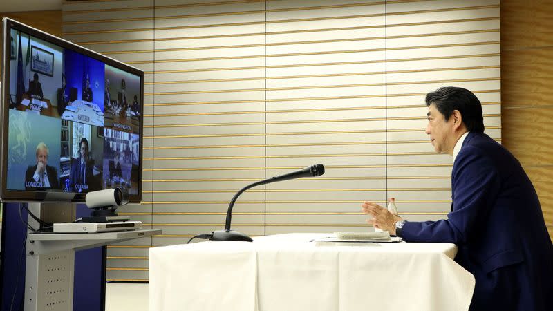 Japan's Prime Minister Shinzo Abe talks with other G7 leaders during a video conference at his official residence in Tokyo, Japan