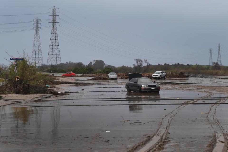 Victoria Avenue near Olivas Park Drive on Tuesday, with several vehicles left stranded in mud. Victoria Avenue was reopened Wednesday afternoon, California Highway Patrol officials said.
