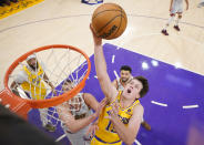 FILE - Los Angeles Lakers guard Austin Reaves, front right, drives to the basket against the Denver Nuggets in the first half of Game 4 of the NBA basketball Western Conference Final series May 22, 2023, in Los Angeles. Reaves has agreed to a four-year deal with the Lakers that could be worth $56 million. (AP Photo/Mark J. Terrill, File)