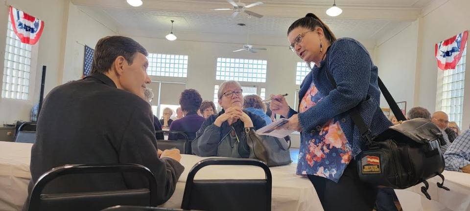 Mike McCorkle, a Democratic challenger to GOP House Speaker Dan Hawkins, speaks to Tonia Goertz, a reporter for the Plainville Times, before the presentation by Hawkins.