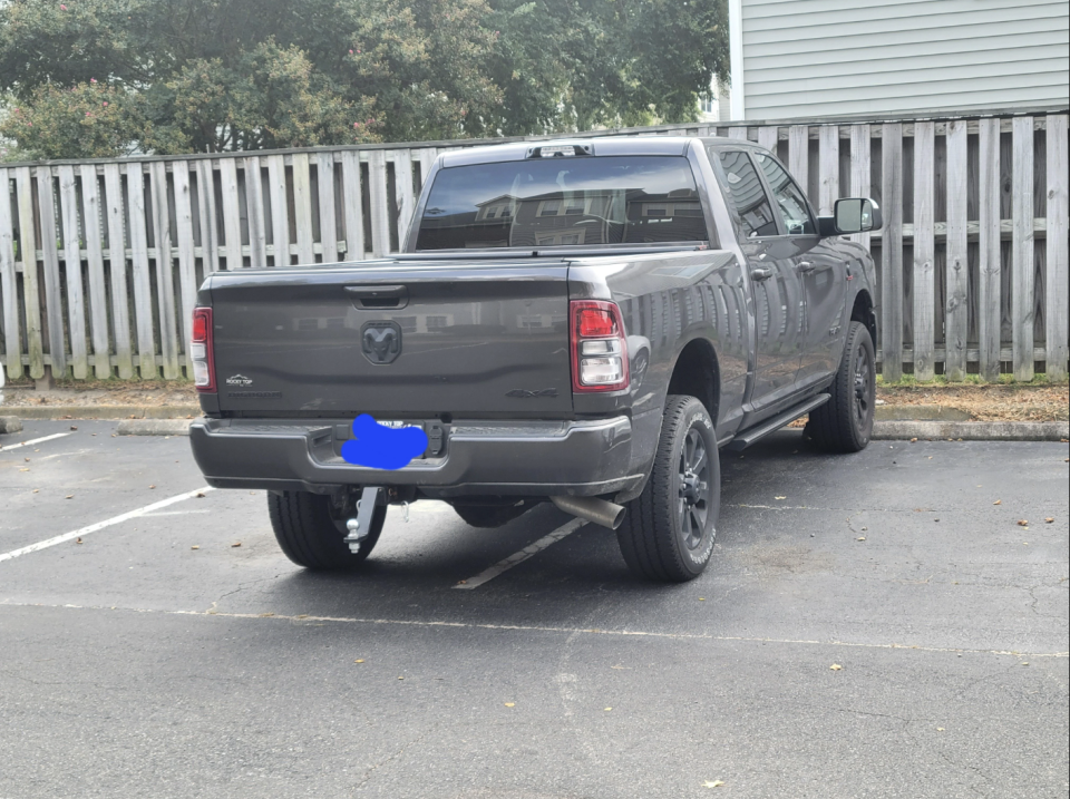 A truck is parked so that it's covering half of two parking spaces