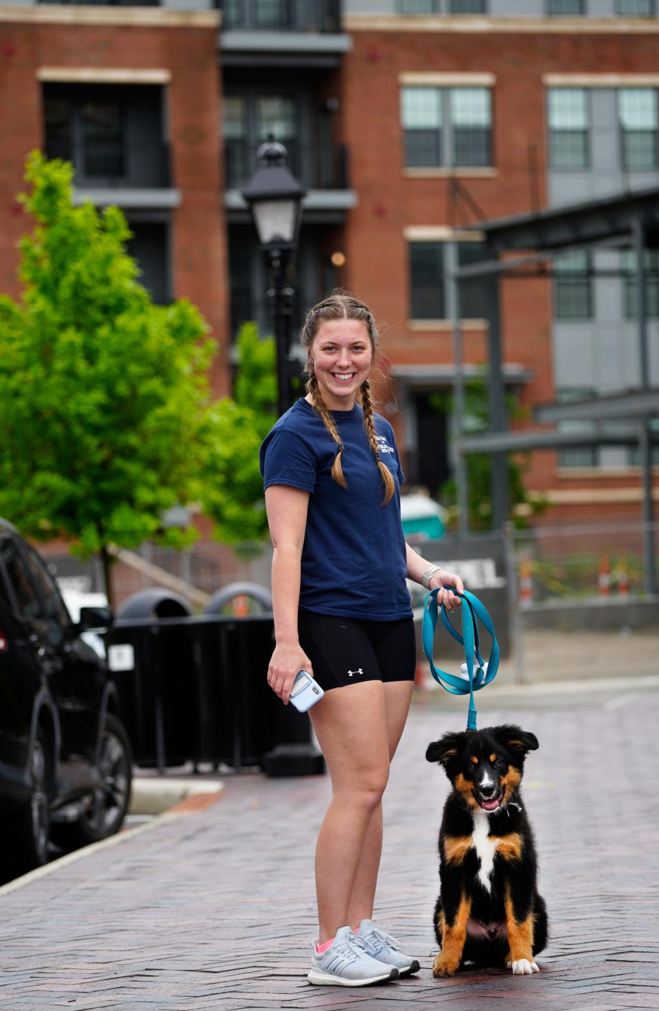 Megan Knoephler, 25, walks her puppy, Rigley, a Bernese Mountain-Border Collie mix next to her apartment at The Residences at MQ near the Montgomery Quarter mixed-use development with shopping, restaurants and office space.