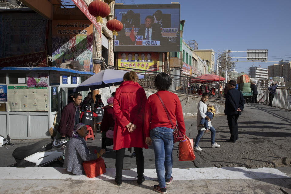 Chinese President Xi Jinping is seen on a screen near a bazaar in Hotan in western China's Xinjiang region, China, Friday, Nov. 3, 2017. The accusation of genocide by U.S. Secretary of State Mike Pompeo against China touches on a hot-button human rights issue between China and the West. (AP Photo/Ng Han Guan)