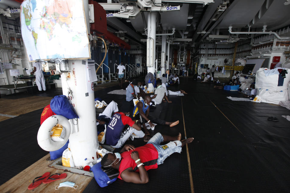 African migrants await disembarkation at the port of Augusta, on the island of Sicily, Italy, Monday, Sept. 27, 2021. The migrants, who were rescued off the coast of Libya, say they were tortured and their families extorted for ransoms in Libya’s detention centers. Their accounts to The Associated Press come as a report commissioned by the United Nations said last week that suspected crimes against humanity have been committed against migrants intercepted at sea and turned over to Libya’s detention centers. (AP Photo/Ahmed Hatem)