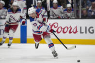 New York Rangers defenseman Adam Fox shoots during the second period of the team's NHL hockey game against the San Jose Sharks, Tuesday, Jan. 23, 2024, in San Jose, Calif. (AP Photo/Godofredo A. Vásquez)