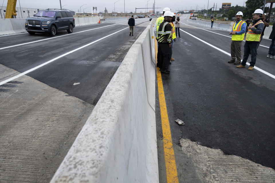 A repaired section of Interstate 95 is finished ahead of schedule as a news conference is held to announce the highway's reopening Friday, June 23, 2023 in Philadelphia. Workers put the finishing touches on an interim six-lane roadway that will serve motorists during construction of a permanent bridge. (AP Photo/Joe Lamberti)