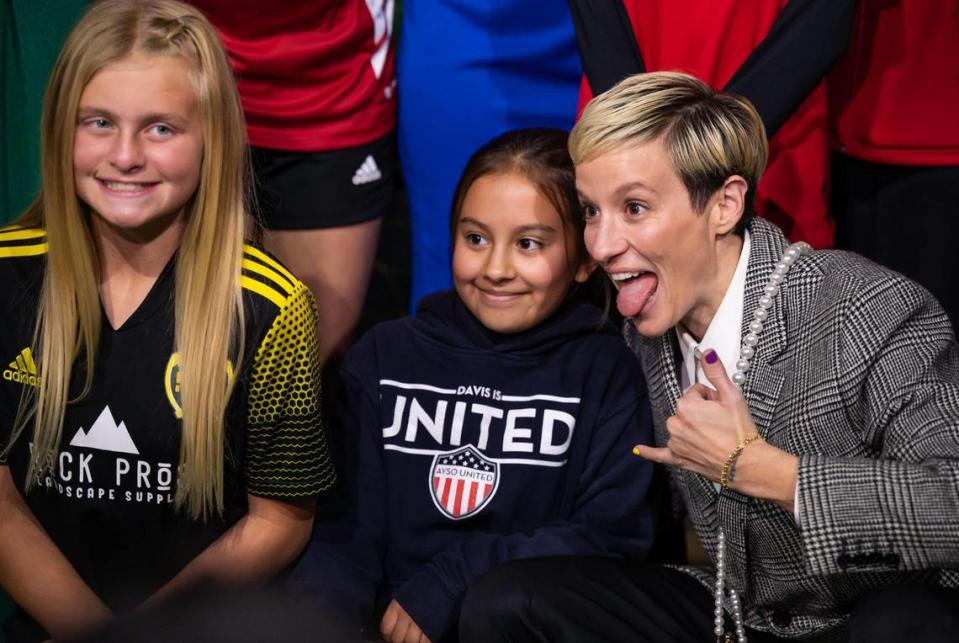 Soccer star Megan Rapinoe, right, a two-time World Cup Champion and Olympic Gold Medalist, lightens the mood as she poses with soccer player and fan Olivia Richards, 11, of Davis, and other players on the red carpet before Rapinoe is inducted during the California Hall of Fame ceremony Tuesday, Dec. 13, 2022, at the California Museum in downtown Sacramento.