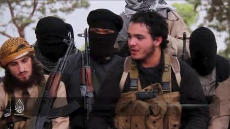 An Islamic State militant who identifies himself as Abu Salman (2nd R) speaks at an undisclosed location, in this still image taken from undated video distributed by Islamic State on November 14, 2015. REUTERS/Social Media Website via Reuters TV