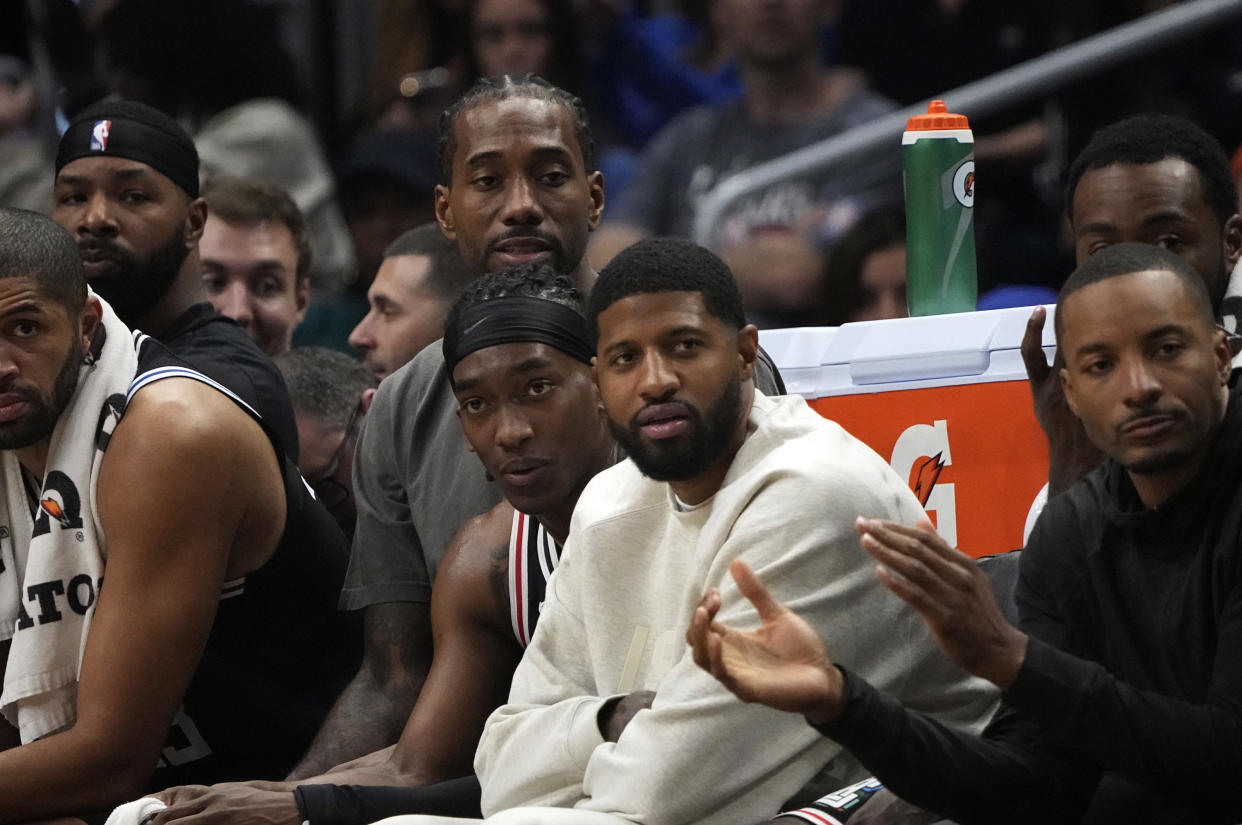 Los Angeles Clippers stars Kawhi Leonard and Paul George watch from the bench during the second half against the Sacramento Kings in December. (Kevork Djansezian/Getty Images)