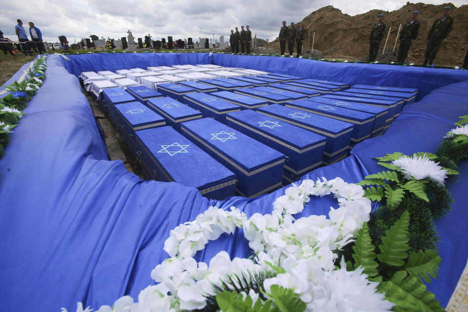 Coffins are seen before burying the remains of Holocaust victims at a cemetery just outside Brest, Belarus, Wednesday, May 22, 2019. Remains of more than 1,000 Holocaust victims were laid to rest on Wednesday in a Belarusian city on the border with Poland after a mass grave was discovered on a building site earlier this year. (Vadzim Yakubionak/ BELTA via AP)