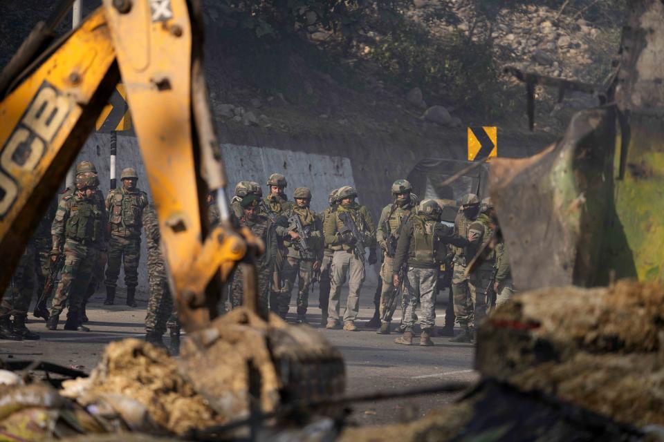 Indian army soldiers inspect the site of a gunbattle at Nagrota, on the Jammu-Srinagar highway, Indian-controlled Kashmir, Wednesday, Dec. 28, 2022. A top police officer, Mukesh Singh, said troops intercepted a truck in the outskirts of Jammu city early Wednesday following its “unusual movement” on a highway. As the troops began searching the truck, gunfire came from inside it, to which the troops retaliated, leading to a gunfight killing four suspected militants, Singh told reporters. (AP Photo/Channi Anand)