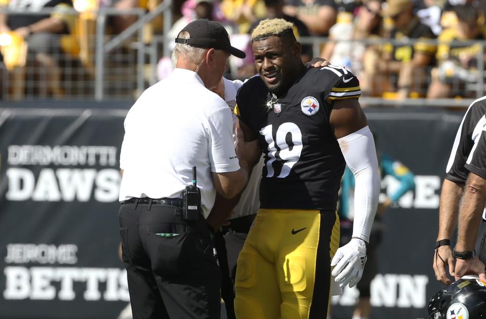 Pittsburgh Steelers WR JuJu Smith-Schuster (19) grimaces after suffering an injury against the Denver Broncos,
