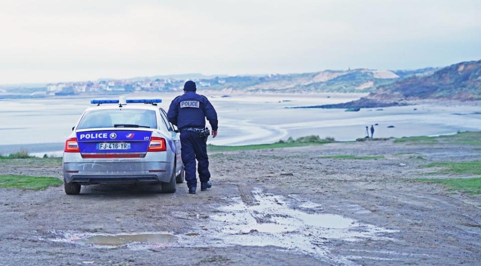 French police look out over the coast at Wimereux, north of Boulogne, at a stretch of beach believed to be used by migrants looking to cross the English Channel (Stefan Rousseau/PA) (PA Wire)