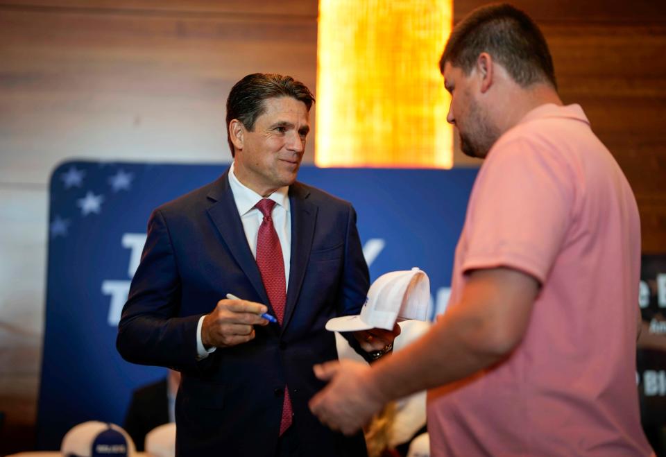 Republican presidential candidate, businessman and pastor Ryan Binkley signs autographs prior to speaking at the Iowa Faith & Freedom Coalition's fall banquet, Saturday, Sept. 16, 2023, in Des Moines, Iowa.