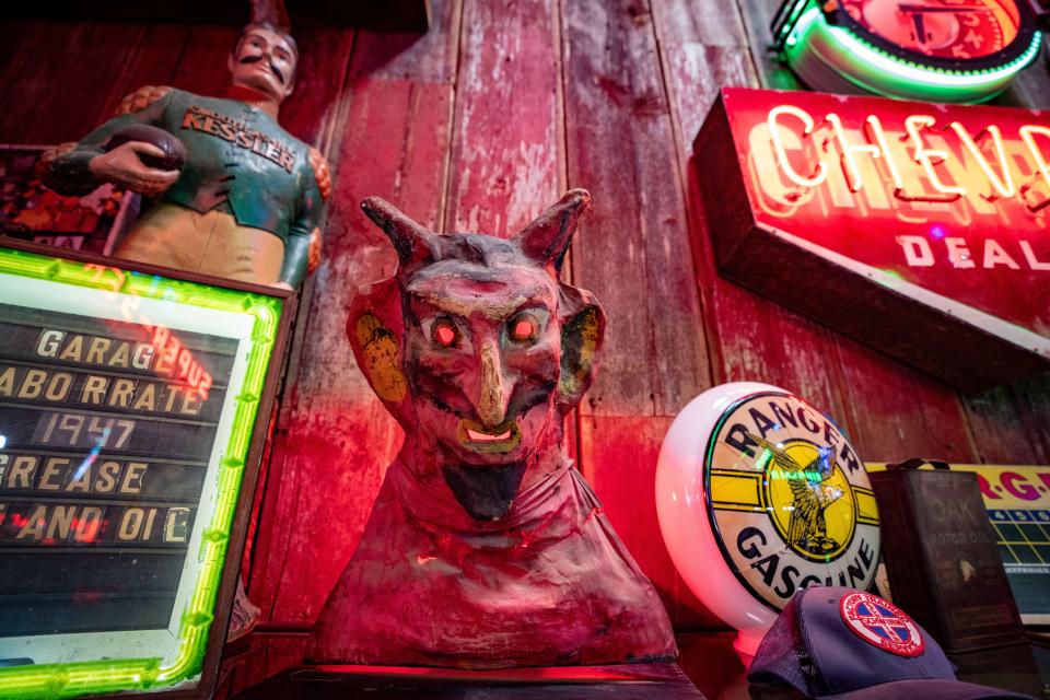 An antique papier mache devil mask sits on a shelf in Rob Wolfe's warehouse in Davenport, Wednesday, Dec. 13, 2023.