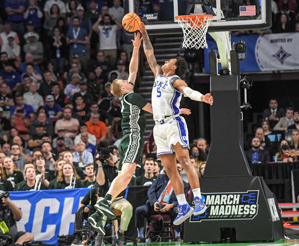 Duke University forward Paolo Banchero (5) blocks the shot of Michigan State University forward Joey Hauser (10) with less than two minutes in the second half of the NCAA Div. 1 Men's Basketball Tournament preliminary round game at Bon Secours Wellness Arena in Greenville, S.C. Sunday, March 20, 2022.