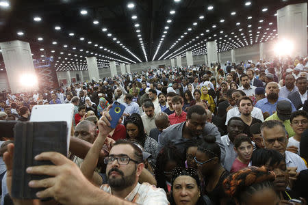 Thousands attend the jenazah. REUTERS/Lucas Jackson