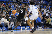 UCLA guard Johnny Juzang (3) defends against Colorado forward Jabari Walker (12) during the first half of an NCAA college basketball game in Los Angeles, Wednesday, Dec. 1, 2021. (AP Photo/Ashley Landis)