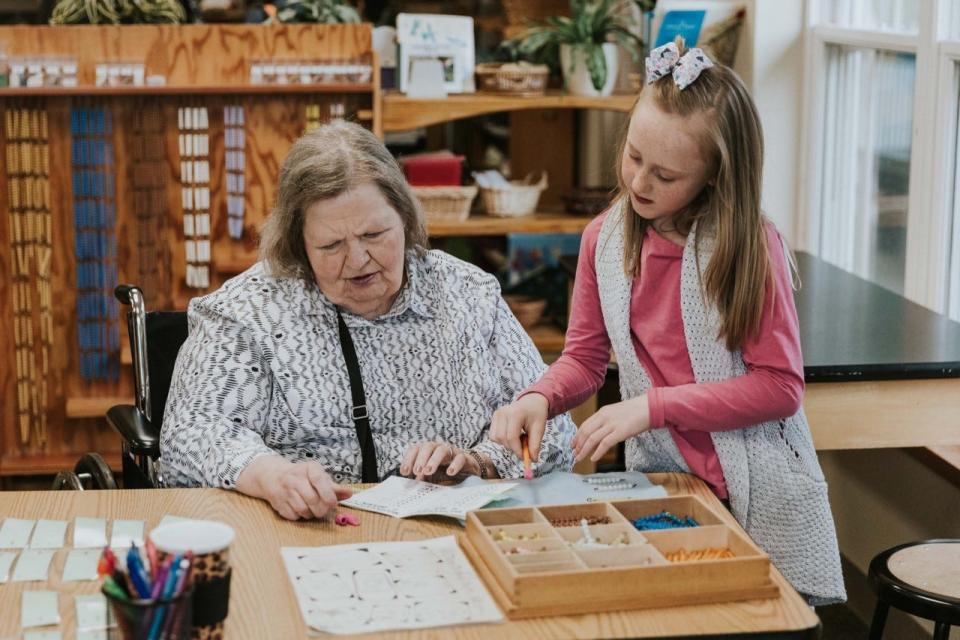 Alexandra VanRiper (right) shows materials to her grandmother, Maureen Smith.