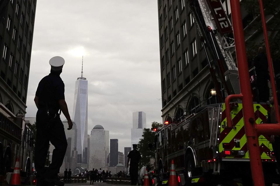 Jersey City firefighters attend a ceremony at the 9/11 memorial during the 13th anniversary of the 9/11 attacks on the World Trade Center, in Exchange Place, New Jersey, September 11, 2014. Until a few months ago, the part of New York City where crowds will gather on Thursday morning to mark the 13th anniversary of the September 11 attacks on the United States had been mostly fenced off to the public.This year, for perhaps the first time since the attacks, a sense of normalcy and openness has taken root in the city blocks where two airliners hijacked by militants from al Qaeda crashed into the World Trade Center's twin towers. (REUTERS/Eduardo Munoz)