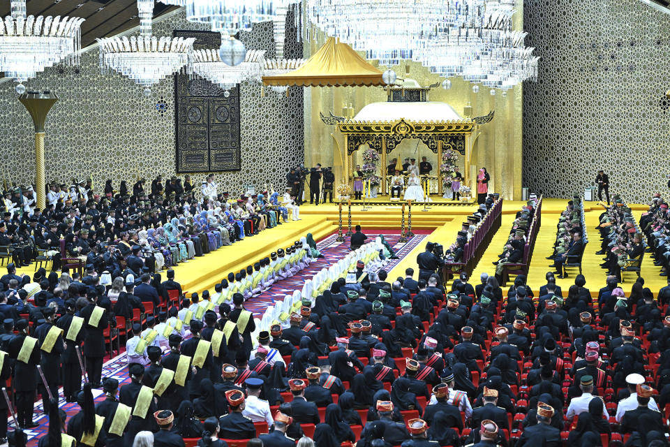 In this photo released by Brunei's Information Department, Brunei's Prince Abdul Mateen and bride Anisha Rosnah, center on stage, attend their wedding reception at Istana Nurul Iman in Bandar Seri Begawan, Brunei Sunday, Jan. 14, 2024. (Brunei's Information Department via AP)