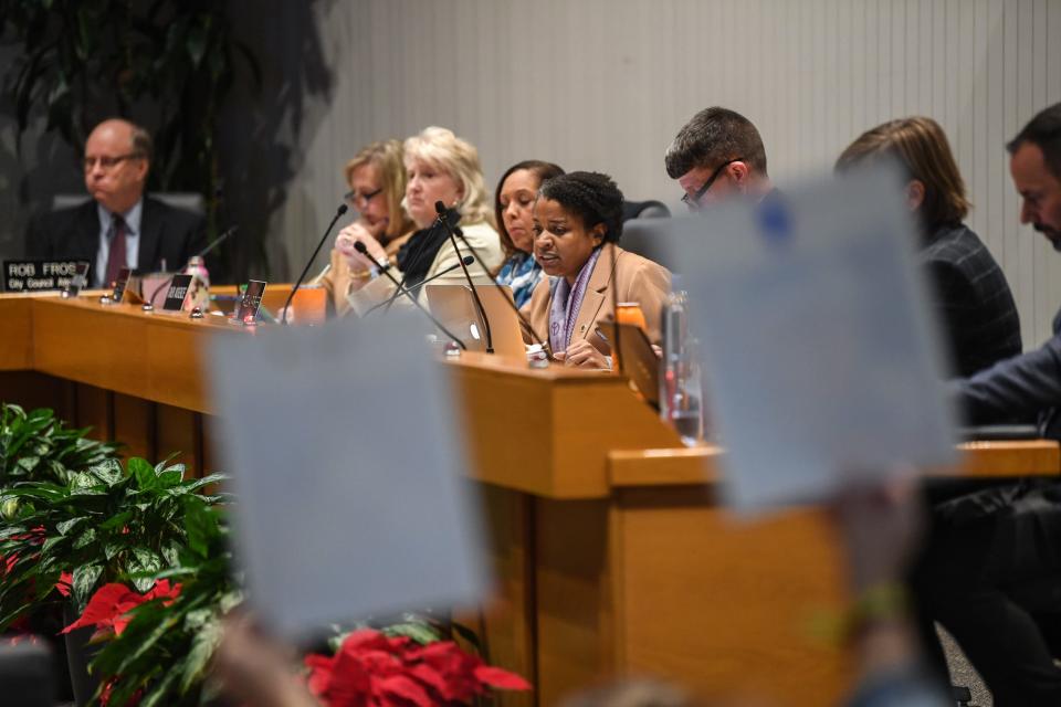 Councilperson Amelia Parker speaks amidst activists holding signs at the Nov. 28 city council meeting.
(Credit: Hannah Mattix/News Sentinel)