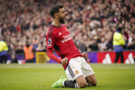 Manchester United's Bruno Fernandes, celebrates after scoring the opening goal with a penalty kick during an English Premier League soccer match between Manchester United and Everton at the Old Trafford stadium in Manchester, England, Saturday, March 9, 2024. (AP Photo/Dave Thompson)