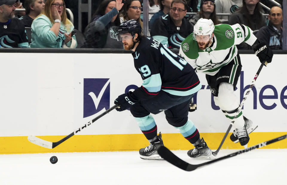 Seattle Kraken left wing Jared McCann (19) moves the puck in front of Dallas Stars center Tyler Seguin (91) during the first period of Game 4 of an NHL hockey Stanley Cup second-round playoff series Tuesday, May 9, 2023, in Seattle. (AP Photo/Lindsey Wasson)