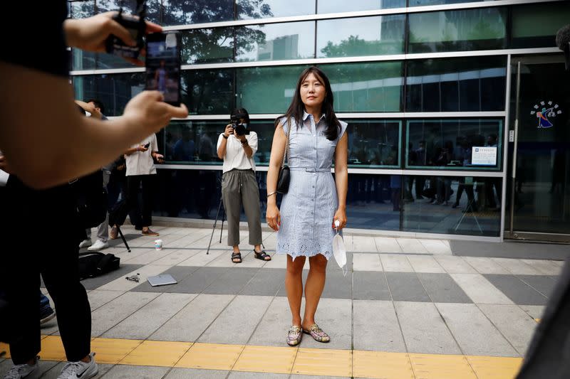 Kara Bos, whose Korean name is Kang Mee-sook when she was adopted in 1984 and is now seeking her biological parents, poses for photographs after attending her trial in front of a court in Seoul