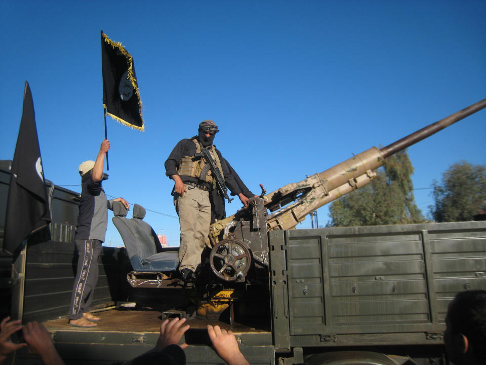 In this file photo taken on March 20, 2014 al-Qaida fighters patrol in a commandeered Iraqi security forces truck in Fallujah, Iraq. Iraqi military officials are warning that efforts to clear militants from Fallujah and parts of nearby Ramadi are proving much more difficult than they anticipated when the jihadists showed up three months ago. That realization, as they acknowledged during a recent tour of special forces operations, casts doubt on Iraq's ability to hold elections in Fallujah next month. (AP Photo, File)