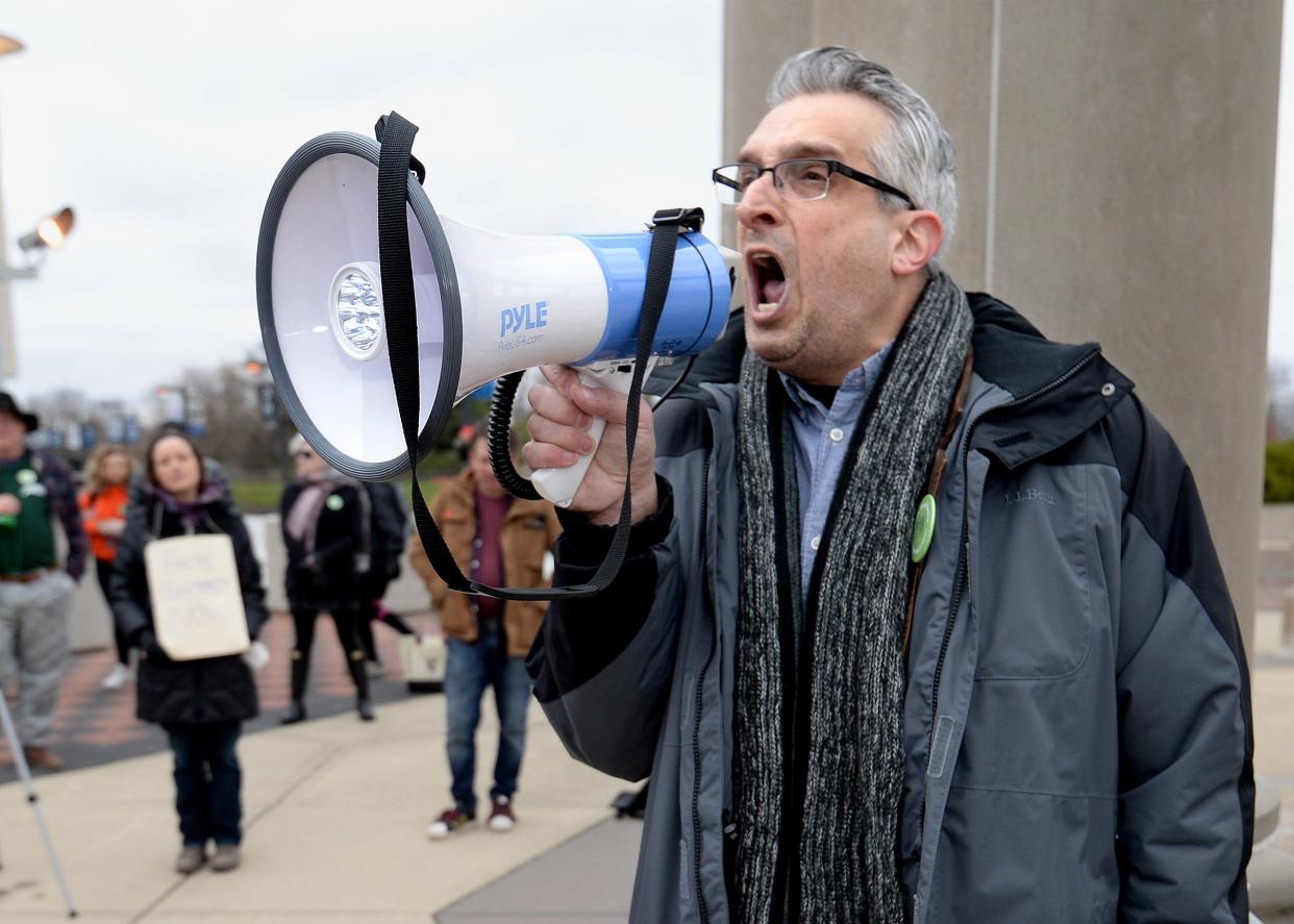 Professor of political theory and philosophy at the University of Illinois Springfield Richard Gilman-Opalsky uses a megaphone to pump up the crowd during a rally held by the UIS teacher's union for a new contract on March 31. [Thomas J. Turney/The State Journal-Register]