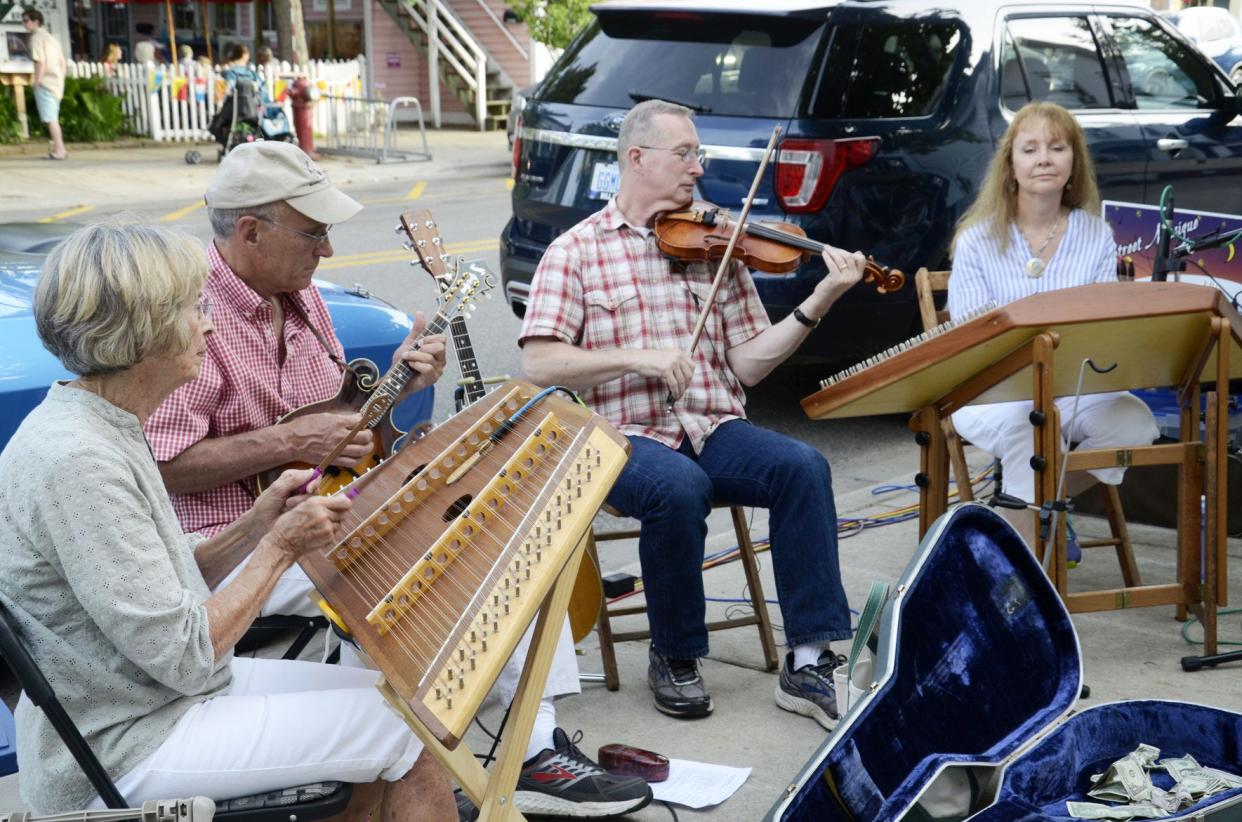 The Pearl Street String Band play outside of Mary Ann Archer Designs in 2019 during Street Musique in Harbor Springs.