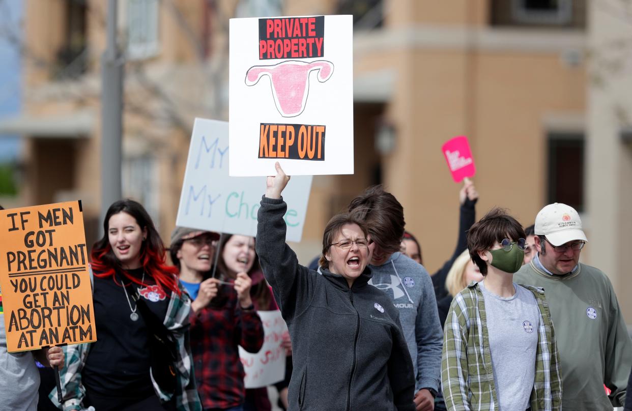 Participants march along the CityDeck in support of Roe v. Wade on May 22, 2022, in Green Bay, Wis.