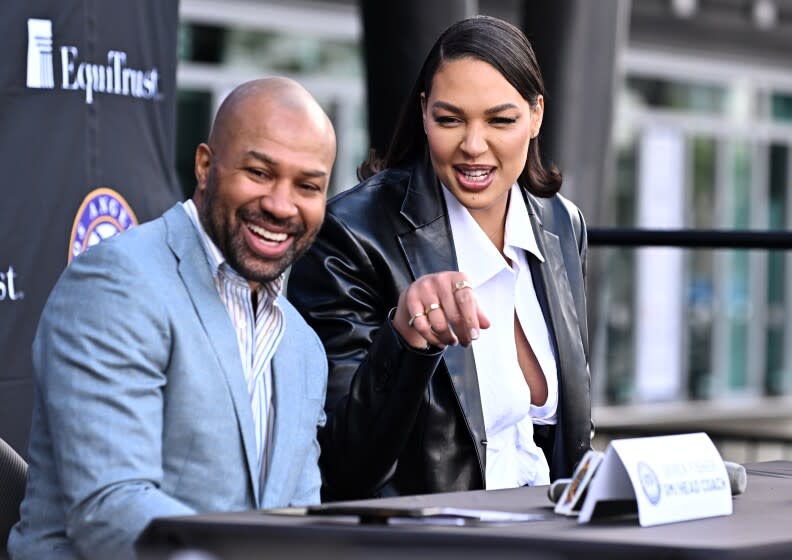 Sparks center Liz Cambage and general manager and coach Derek Fischer answer questions at a news conference