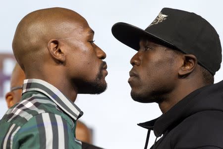 Undefeated WBC/WBA welterweight champion Floyd Mayweather Jr. (L) faces off with challenger Andre Berto during a news conference at MGM Grand Hotel & Casino in Las Vegas September 9, 2015. REUTERS/Las VegasSun/Steve Marcus