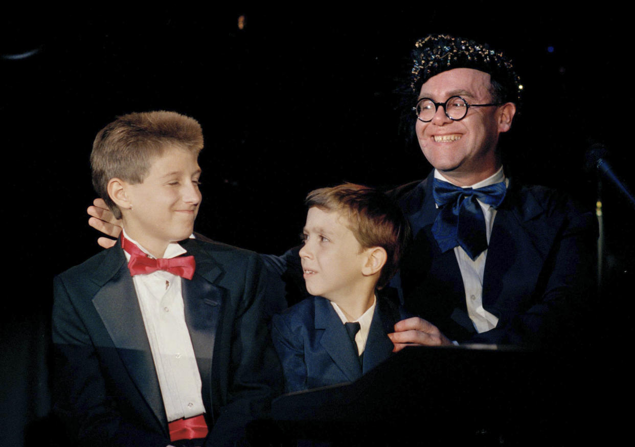 AIDS activist Ryan White is seen far left of British pop singer Elton John at the "For the Love of Children" benefit for children with AIDS and other serious illnesses in Los Angeles in 1988.