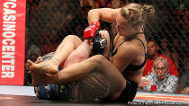 Ronda Rousey tries to slap on her famous armbar submission against Sarah Kaufman. (Credit: Tracy Lee for Y! Sports)