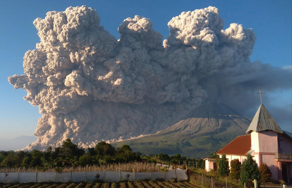 Mount Sinabung spews volcanic material during an eruption in Karo, North Sumatra, Indonesia, Tuesday, March 2, 2021. The 2,600-metre (8,530-feet) volcano is among more than 120 active volcanoes in Indonesia, which is prone to seismic upheaval due to its location on the Pacific "Ring of Fire," an arc of volcanoes and fault lines encircling the Pacific Basin. (AP Photo/Mukhsil Lubis)