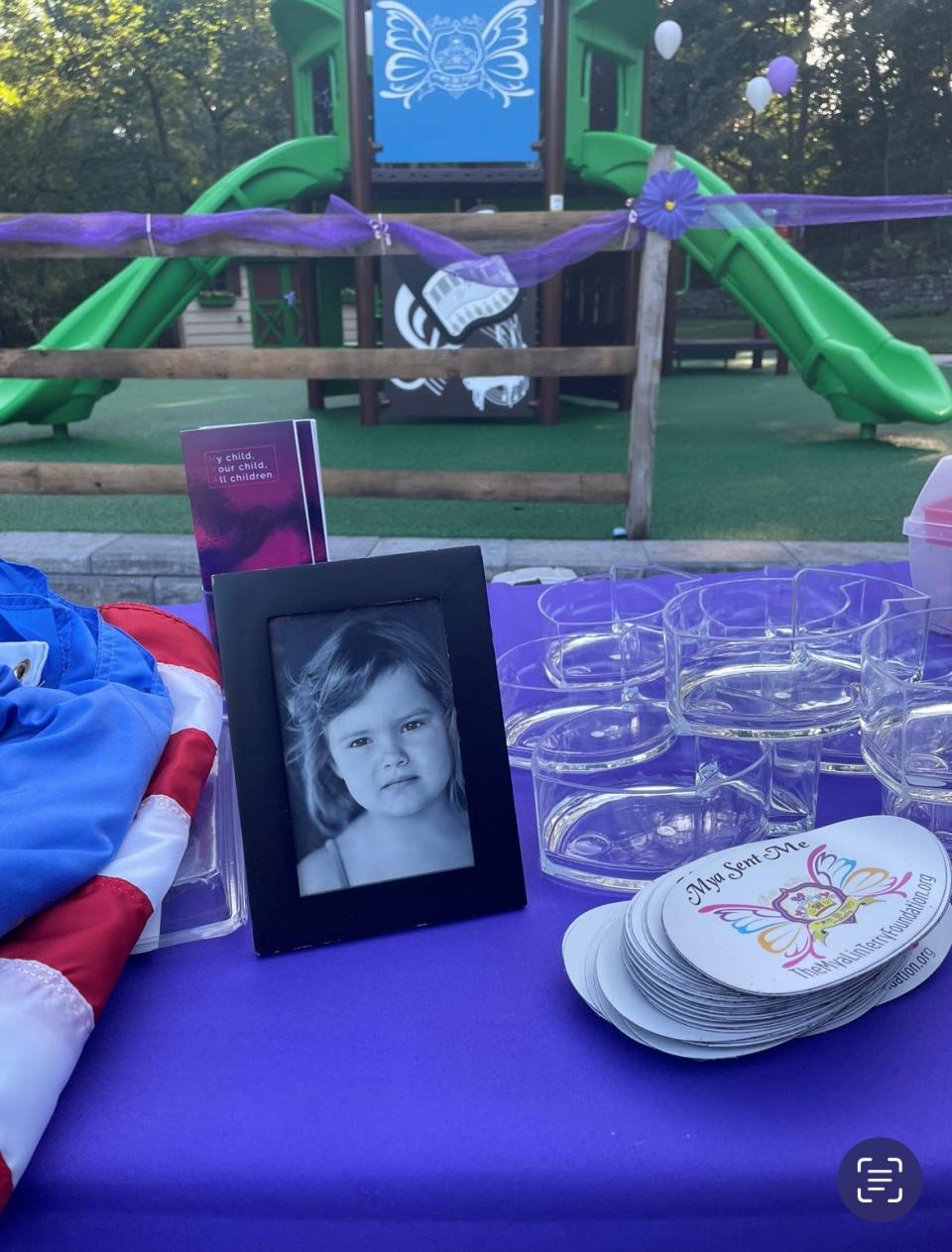 A picture of Mya Lin Terry, who died from cancer in 2013, on a table in front of the new Where Angels Play playground in Ocean Township.