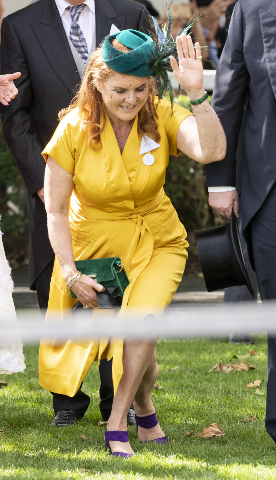 Sarah, Duchess of York curtsies to the Queen as the carriage procession passes. [Photo: Getty]