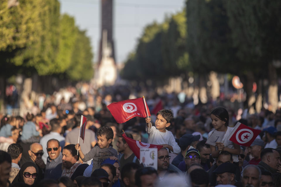 Children wave Tunisian flags as supporters of independent Tunisian Presidential candidate Kais Saied attend a rally on the last day of campaigning before the second round of the presidential elections, in Tunis, Tunisia, Friday, Oct. 11, 2019. (AP Photo/Mosa'ab Elshamy)