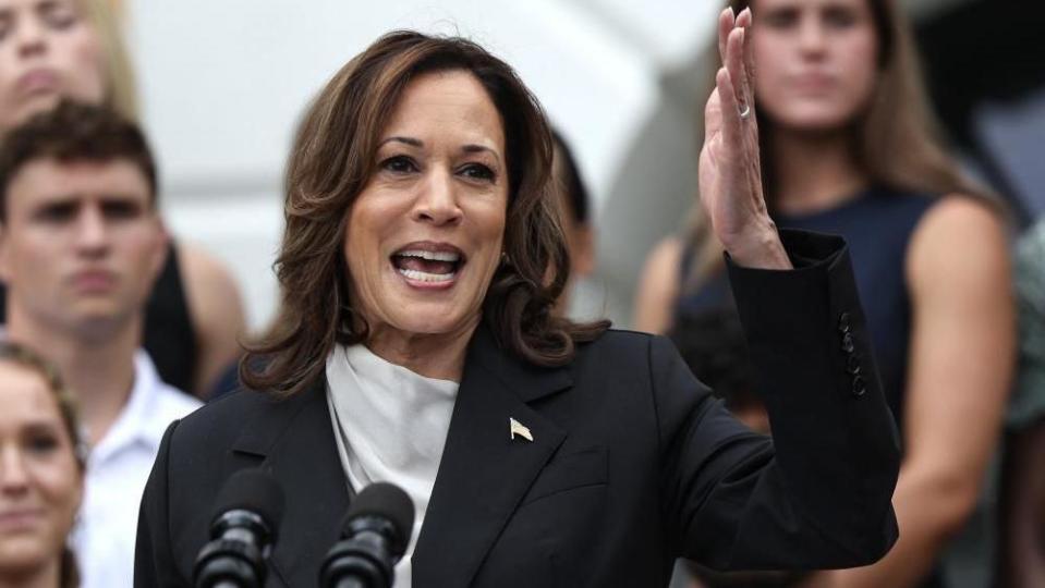 Kamala Harris gestures with her hand in the air
