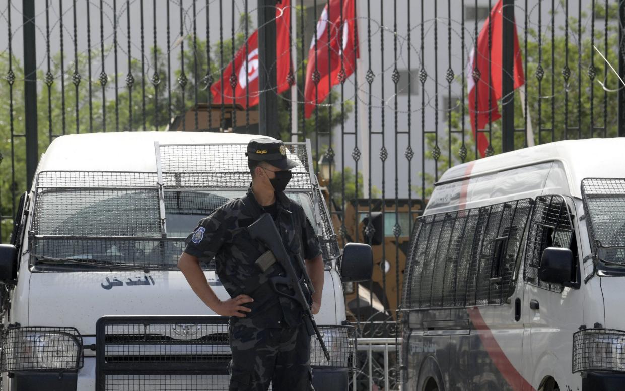 Tunisian police stand guard outside the parliament in Tunis on July 27 - Getty