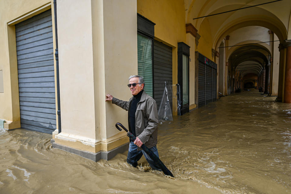 A pedestrian walks in a flooded street in Castel Bolognese, near Imola, on May 17.<span class="copyright">Piero Cruciatti—Anadolu Agency/Getty Images</span>