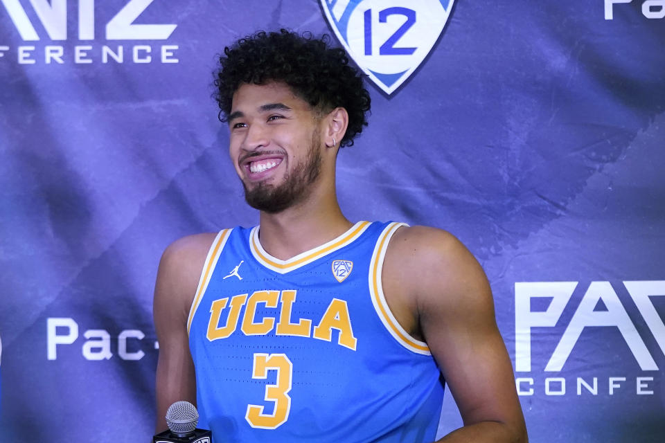 FILE - UCLA's Johnny Juzang smiles during Pac-12 Conference NCAA men's college basketball media day in San Francisco, in this Wednesday, Oct. 13, 2021, file photo. UCLA is No. 2 in The Associated Press Top 25 men's college basketball poll, released Monday, Oct. 18, 2021. Leading scorer Johnny Juzang (16.0 ppg) headlines a Bruins roster that returns nearly intact after last year’s run from the First Four to the Final Four, where they lost to Gonzaga on a halfcourt shot in an overtime classic. (AP Photo/Jeff Chiu, File)