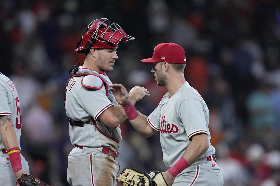 Philadelphia Phillies' J.T. Realmuto, left, and Kody Clemens celebrate after a baseball game against the Houston Astros Saturday, April 29, 2023, in Houston. The Phillies won 6-1. (AP Photo/David J. Phillip)