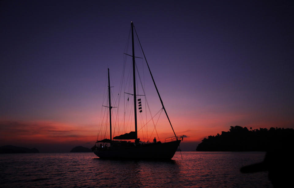 In this Feb. 9, 2014 photo, Meta IV, a $1 million yacht offering cruises among the reefs and islands, is silhouetted at sunset near Nyuang Wee Island, in Mergui Archipelago, Myanmar. Isolated for decades by the country’s former military regime and piracy, the Mergui archipelago is thought by scientists to harbor some of the world’s most important marine biodiversity and looms as a lodestone for those eager to experience one of Asia’s last tourism frontiers before, as many fear, it succumbs to the ravages that have befallen many of the continent’s once pristine seascapes. (AP Photo/Altaf Qadri)