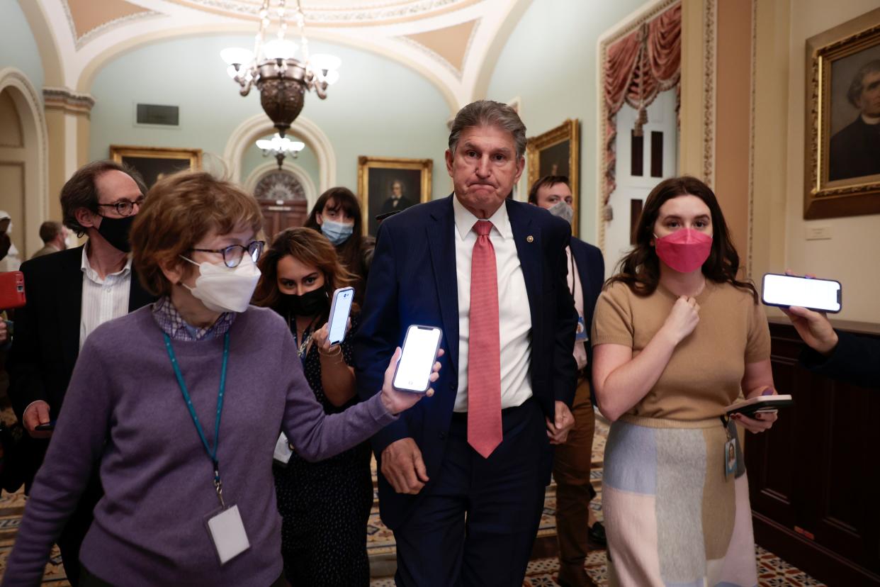 Sen. Joe Manchin is followed by reporters as he leaves a meeting at the US Capitol